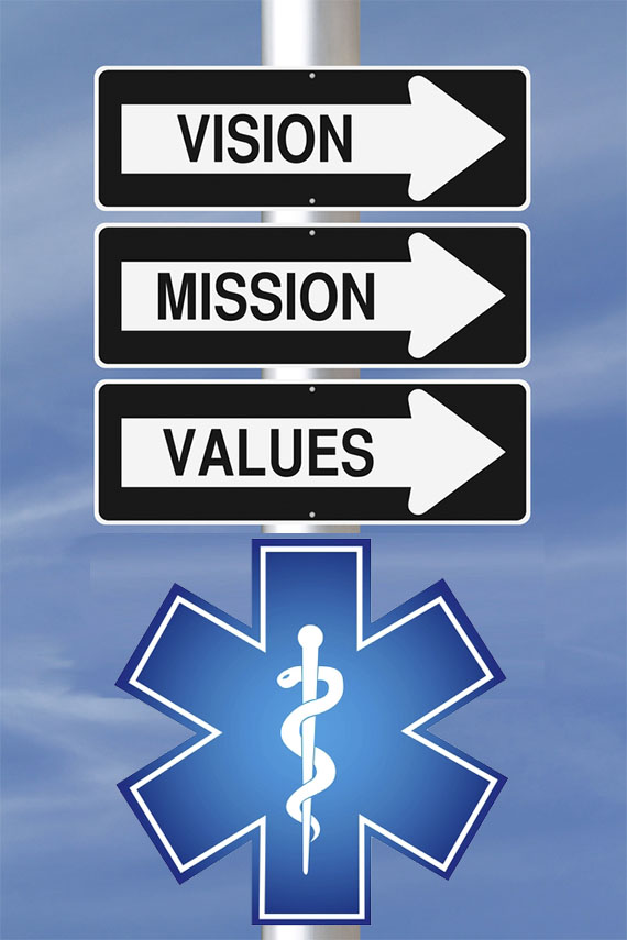 signs reading vision mission values over a medical symbol