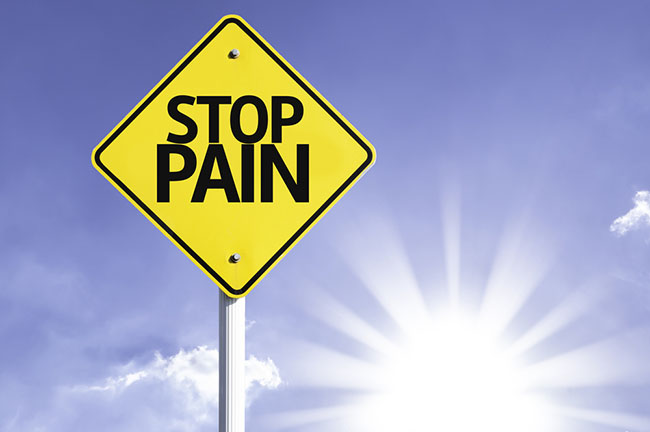 sign reading stop pain in front of a sunny sky