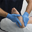 medical professional holding a patient's foot