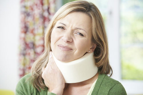 person with a neck brace on after experiencing whiplash injuries
